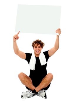 Athlete pointing towards blank banner ad over his head