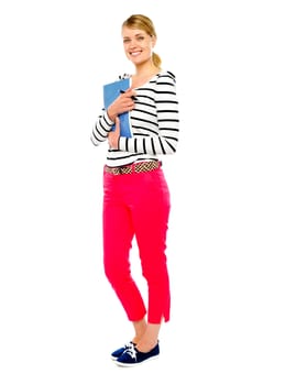 Gorgeous lady posing with pen and notebook. Smiling at camera