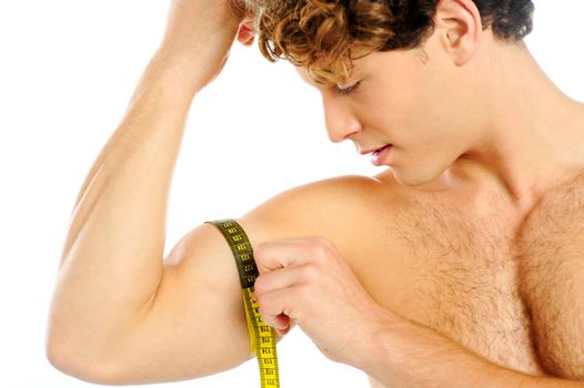 Handsome guy measuring his biceps with tape, closeup