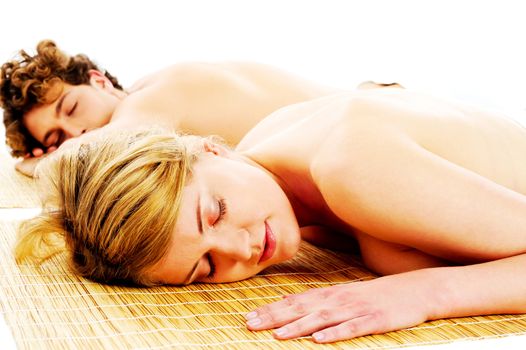 Resting caucasian couple lying on carpet in a spa center