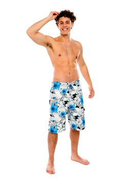 Shirtless muscular guy in swimming costume isolated against white background