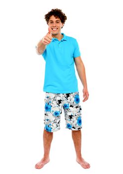 Thumbs-up from a casual guy. Isolated over white