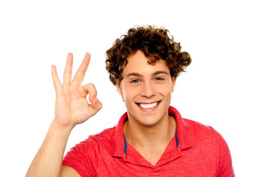 Curly hair guy gesturing excellence sign. Isolated on white