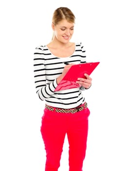 Young girl writing makes notes on clipboard. Isolated over white