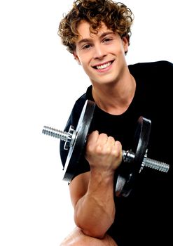Smiling athlete doing exercise with dumbbell
