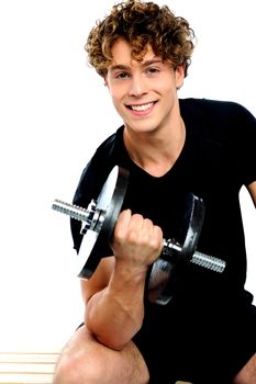 Fit trainer doing biceps exercise against white background