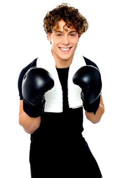 Boxer boy in sports outfit ready to punch you. Towel around his neck