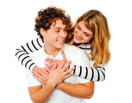 Smiling playful couple looking at each other over white background
