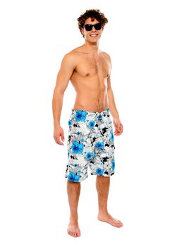 Smiling young man standing in swimwear