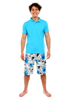 Man standing in shorts with smile on his face. Isolated