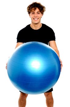 Man in sportswear holding big ball isolated against white background