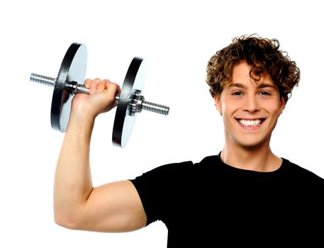 Powerful muscular young man lifting weight, smiling pose