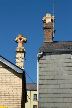 A pair of unusual chimney pots featuring inverted outlets.