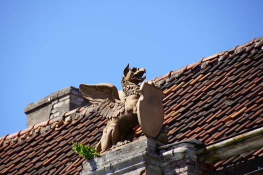 Old sculpture on a roof of the house