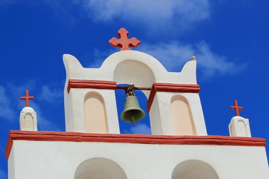 Close up of a white and red belfry of a typical greek church by beautiful weather, Oia, Santorini, Greece