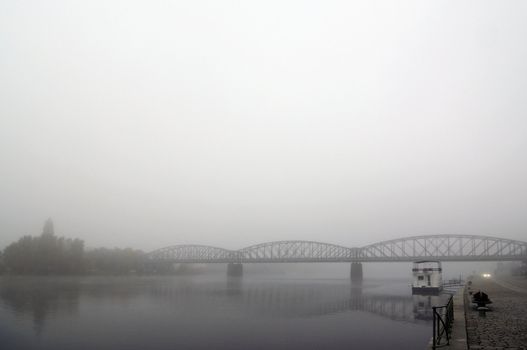 Prague railway bridge in early morning fog