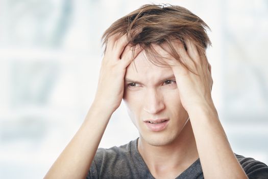 Human at home suffering from headaches