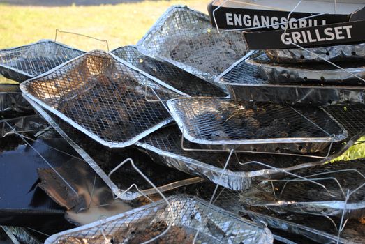 A pile of used disposable grills.