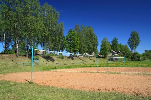 volleyball net amongst summer tree