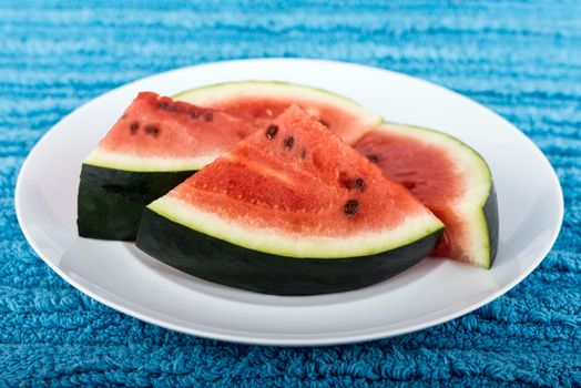 Image of fresh watermelon slices on white plate
