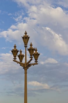 Ancient lamp against the blue sky in the morning