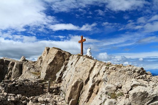 old trench and cross in Castellazzo mount, Rolle pass. Trentino, Italy