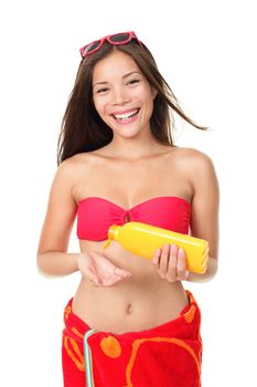 Sunscreen summer vacation woman isolated on white background holding suntan lotion wearing bikini and red towel in studio. Beautiful mixed race Asian Chinese / Caucasian female model smiling happy holding cream bottle.