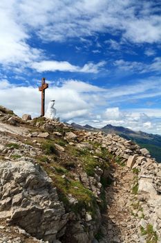 old trench and cross in Castellazzo mount, Rolle pass. Trentino, Italy