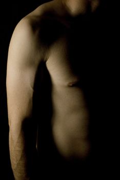 sexy fit naked male body on black background low key