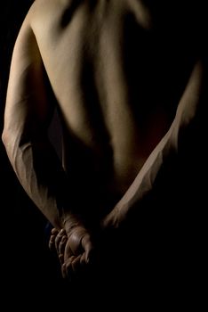 sexy fit naked male body on black background low key