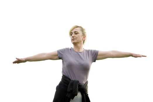 middle aged woman keeping fit with exercises in a park