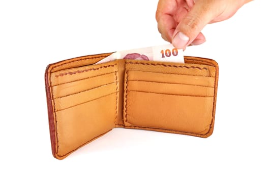 Open brown leather wallet with money