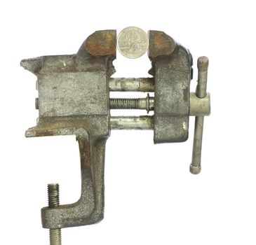 Quartersqueezed tightly in a metal bench vice
