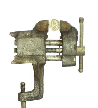 Nickel squeezed tightly in a metal bench vice
