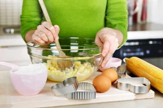 Mixing ingredients for baking cookies in glass bowl