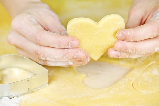 Making heart shaped shortbread cookies with cutters