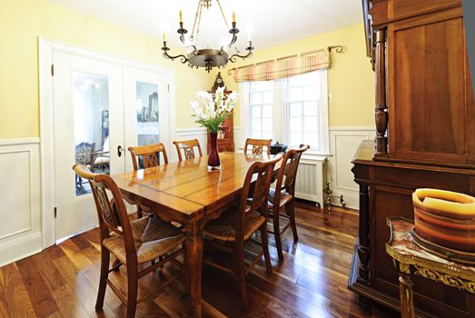 Dining room interior with wooden table and chairs in house