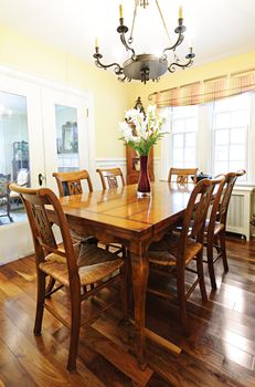 Dining room interior with antique wooden table and chairs in house