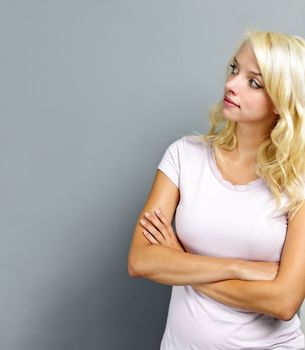 Portrait of young blonde caucasian woman looking to the side and up