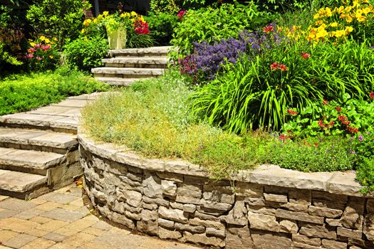 Natural stone landscaping in home garden with stairs and retaining walls