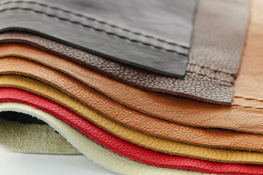 Natural leather upholstery samples with stitching in various colors