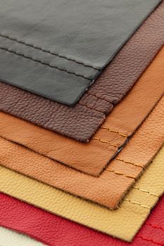 Natural leather upholstery samples with stitching in various colors