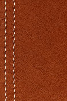 Leather background in brown with white stitches