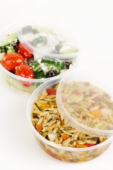 Two servings of prepared salad in plastic takeaway containers