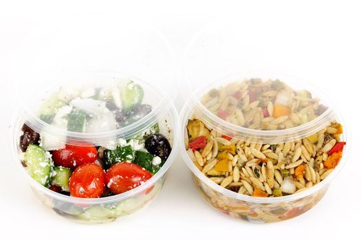 Two servings of prepared salad in plastic takeaway containers