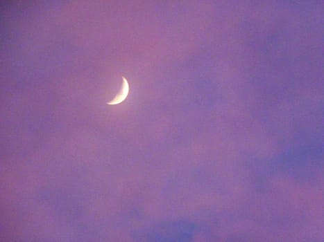 crescent moon against a purple sky