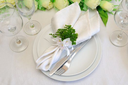 A fragment of serving a festive table cloth with violets and ribbon