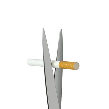 Cigarette is being cut by scissors