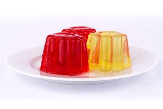 Gelatin of different colors on a white dish.