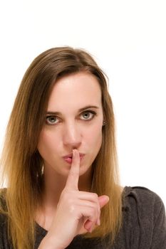 woman holding a finger to her mouth to shh on white background